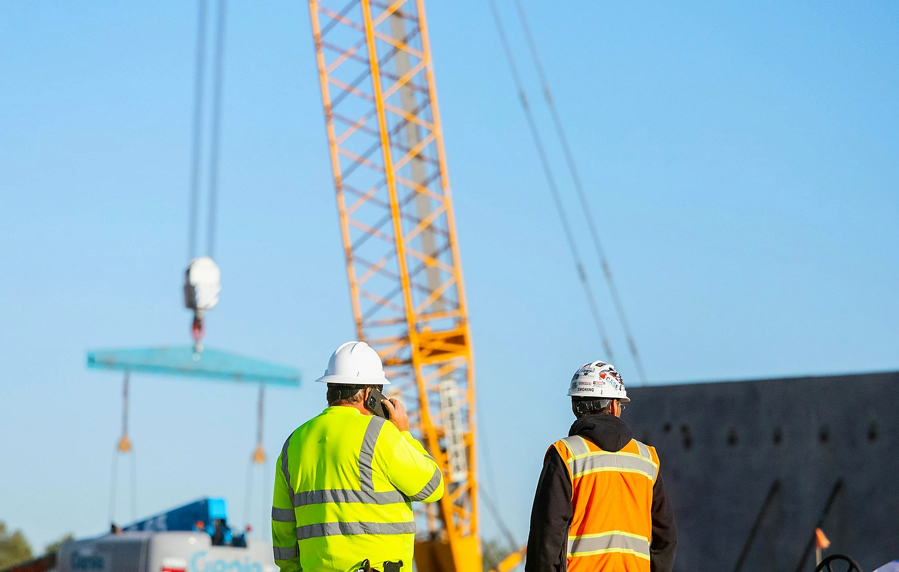Crane crew coordinating a lift at a construction site